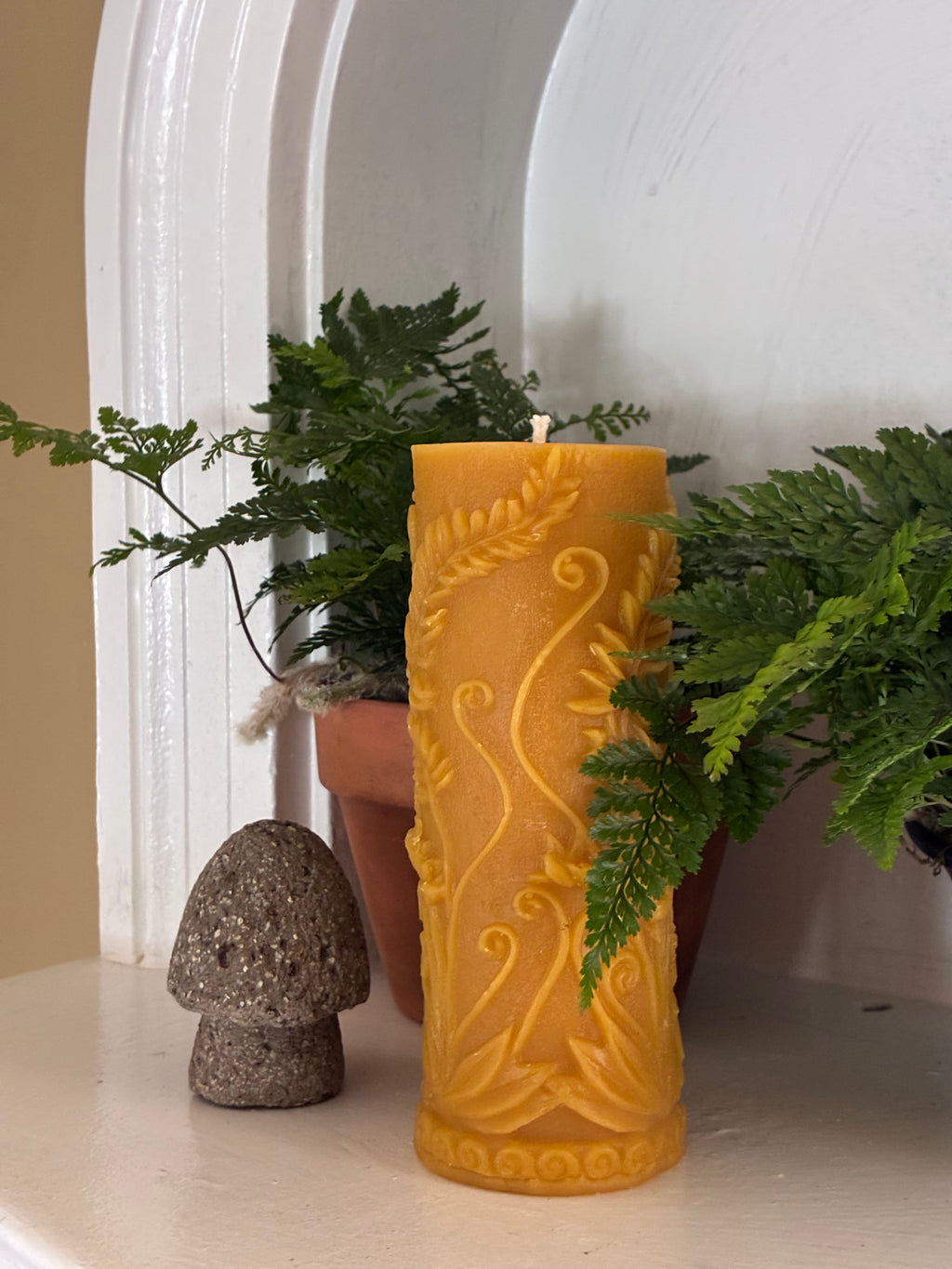 100% Fern Pillar Beeswax Candle on shelf, front view